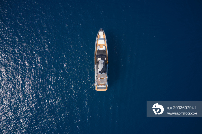 Big yacht for millionaires in the sea drone view. Luxurious gray blue Mega yacht on dark water top view. Big gray super boat on the water aerial view.