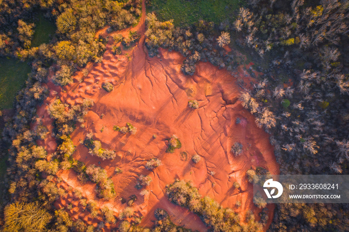 Gant, Hungary - Aerial view of abandoned bauxite mine, bauxite formation, the red mountains resembling Martian landscape. Red and orange colored surface, bauxite texture, warm autumn colors.