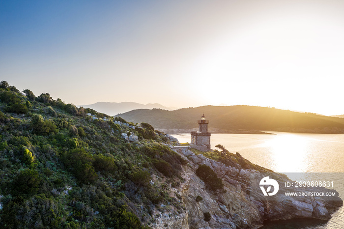 Aerial Poros Greece Dana lighthouse.Romantic Sunset backlight. Greek islands on background. Magic golden light photo. Aerial drone view.