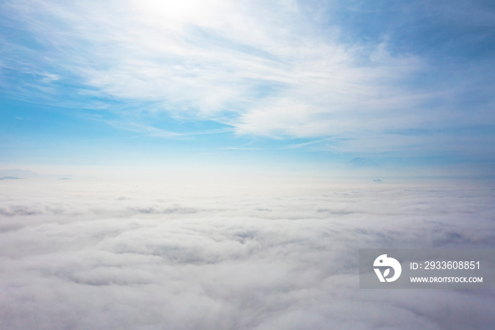 Aerial top view cloudscape. Texture of clouds. View from above. Sunrise or sunset over clouds in sunny weather