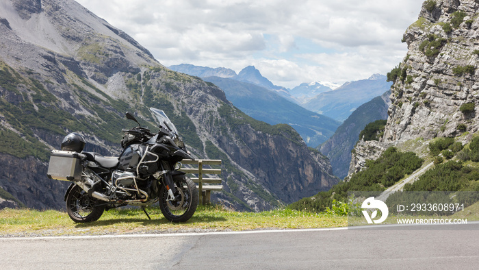 Unrecognisable motorcycle and driver in the Alps