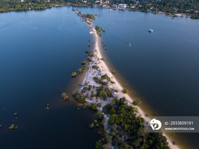 Beautiful aerial view of beach with clear sand, boats and bungalows on Rio Tapajos in Alter do Chao village, Para, Brazil. Travel, amazonia, vacation, adventure, environment and conservation concept.