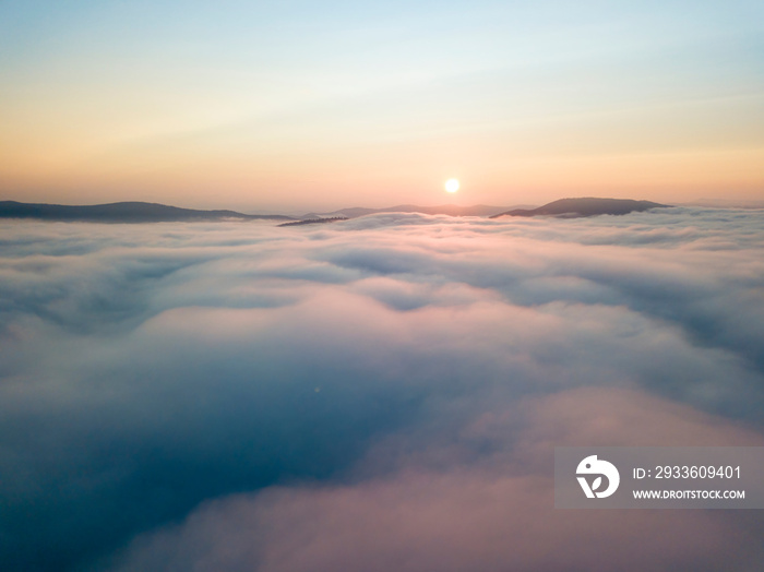 Sunrise over the fog in the Ukrainian Carpathians. Aerial drone view.