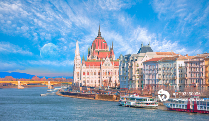 Budapest Parliament building at dusk on the Danube river with full moon - Budapest, Hungary  Elements of this image furnished by NASA