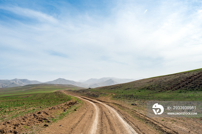 Country dirt road in mountains valley