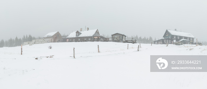 Winter landscape. Panoramic view. Foggy day in a small mountain village. Mobile photography.