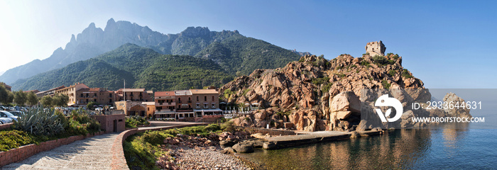 A rock with an old defensive stone tower above sea level in the city of Porto on the island of Corsica in France.