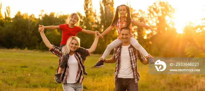 Happy family: mother father and child daughter on nature on sunset