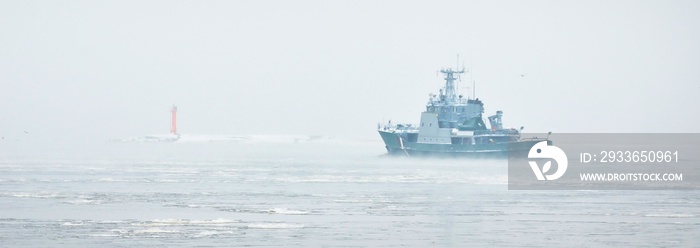 Coast guard ship sailing during the storm. Winter. Fog, waves, rough weather. Baltic sea. Transporta