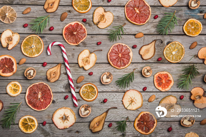 New Year composition of dried fruits on a wooden table. Christmas background. Flat lay.Top view