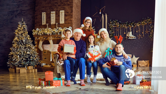 Big family in a room with a fireplace in Christmas.