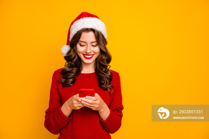 Photo of amazing lady holding telephone in hands wear knitted pullover and santa hat isolated yellow