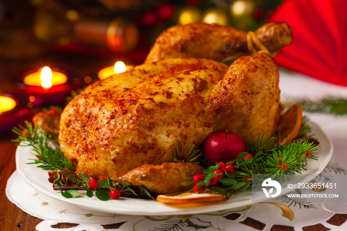 Roasted whole chicken with Christmas decoration.