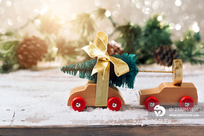 Christmas tree on toy car over festive background. Christmas holiday celebration concept