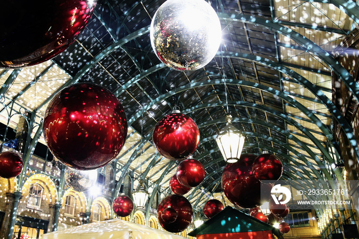 Christmas decoration lights at night in Covent Garden London England UK during the holiday festive s