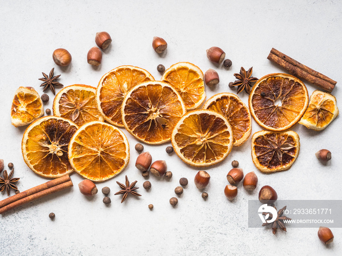 Bright Christmas or New Year background - dry orange slices and spices. Ingredients for making winte