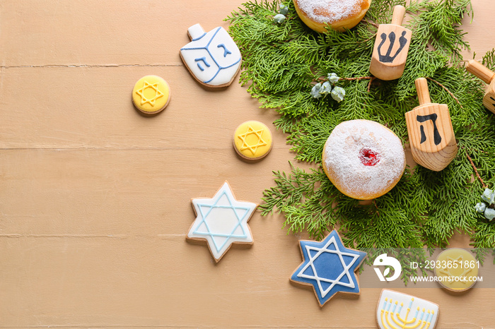 Symbols of Hanukkah and Christmas decor on color wooden background