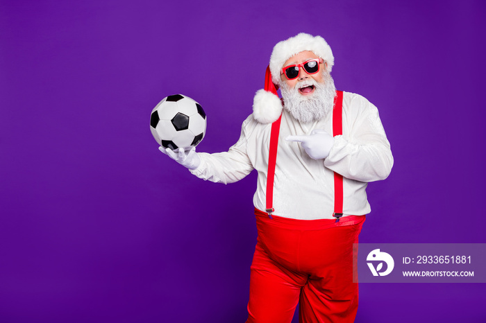 Photo of grey haired santa holding football ball demonstrating new leather model of football ball fo