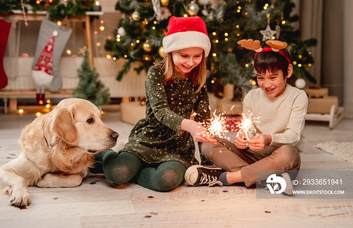 Little girl and boy holding sparklers