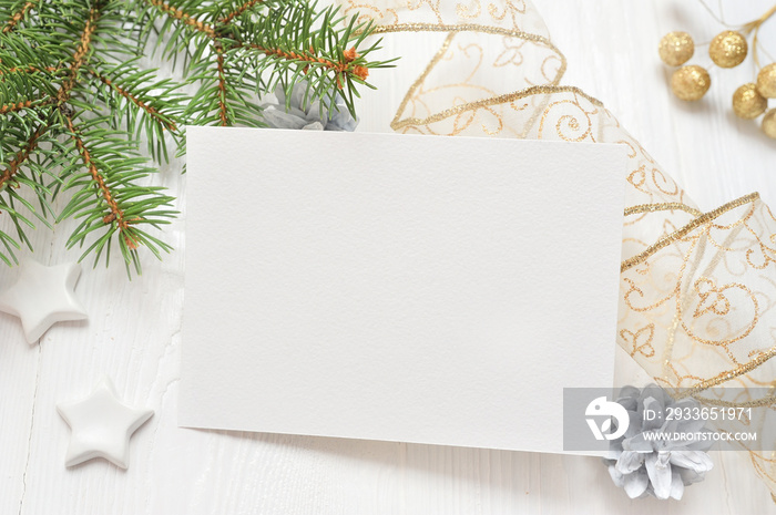 Empty white sheet of paper on a white Christmas background of fir branches and cones. Letter on xmas