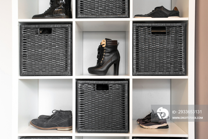 Organized shoe rack in modern interior, various footwear on wooden shelf, storage for shoes in a mod