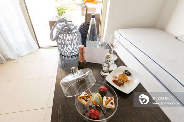 Hotel room interior with welcome gift sweets on the table