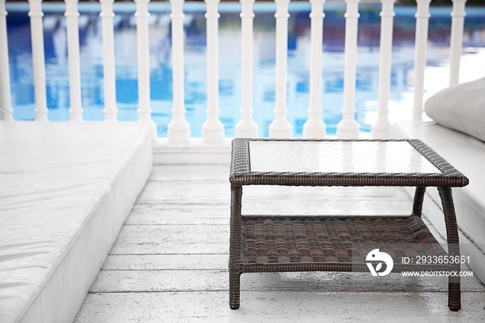 Rattan table near swimming pool in luxury hotel