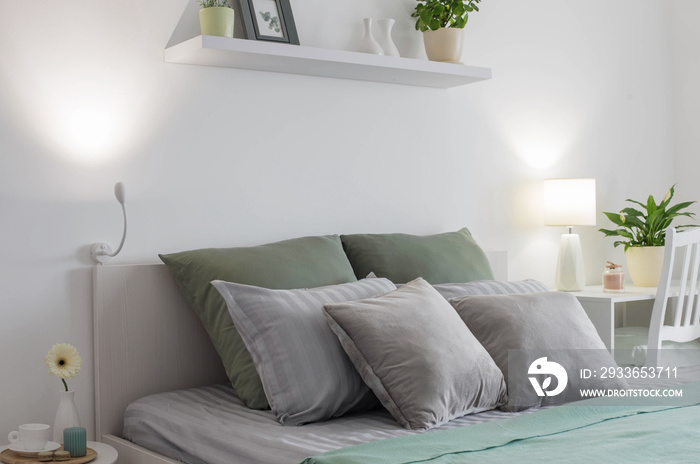 white bedroom with gray and green linens