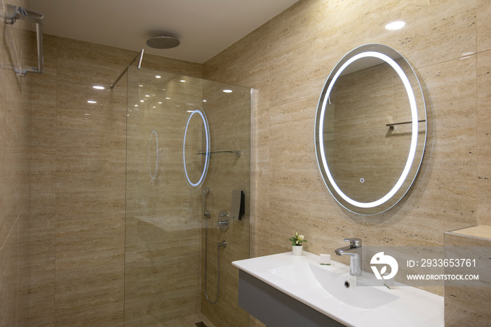 Interior of a luxury hotel bathroom with beige marble walls