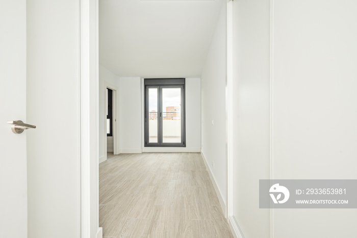 Entrance door to empty room with freshly painted walls with wardrobe with small sliding doors