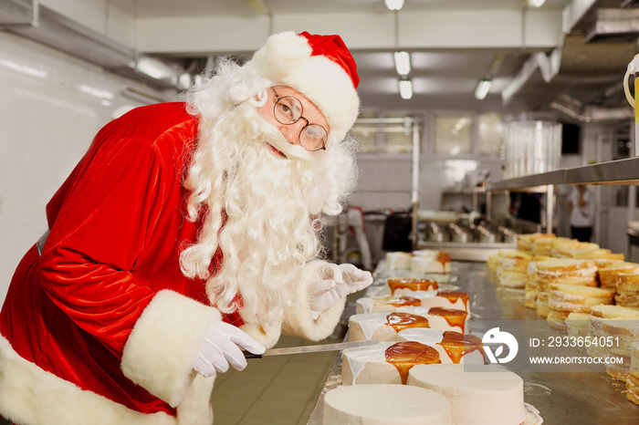 Father Christmas bakes a cake in the kitchen at Christmas.