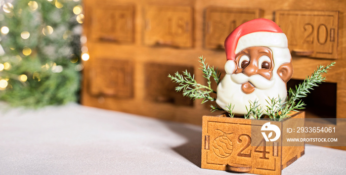 Wooden christmas advent calendar with chocolate santa claus