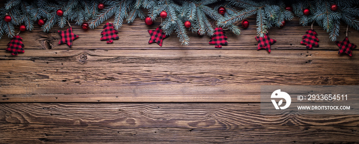 Cozy copy space background with spruce branches and Christmas tree ornaments on barn wood