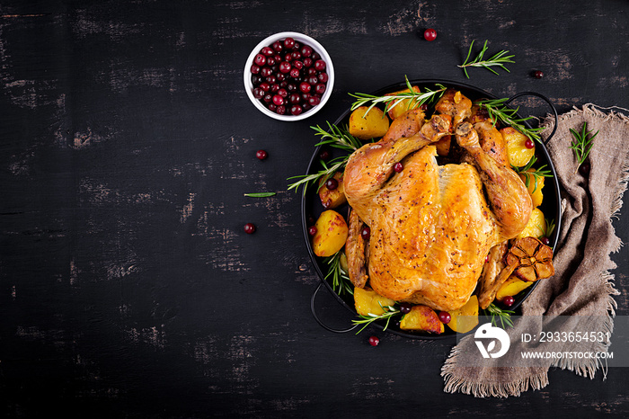 Baked turkey or chicken. The Christmas table is served with a turkey, decorated with bright tinsel. 
