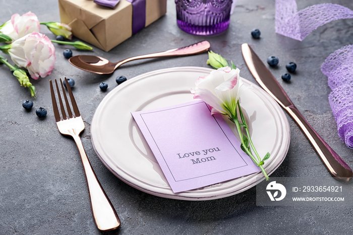 Elegant table layout for dinner with flower and greeting card