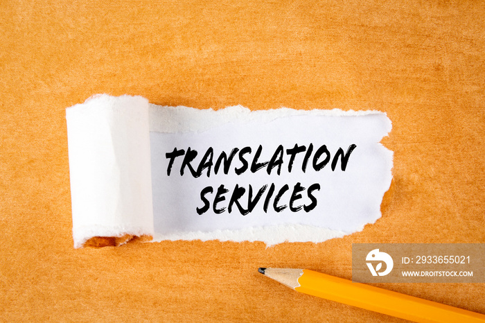 Translation Services. Business concepts. Pencil on an orange cardboard background