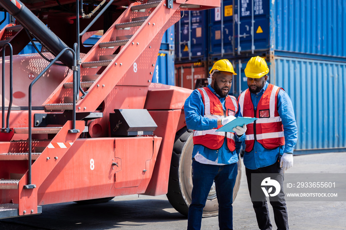 Two male engineers in a container shipping company Consulting to check the order for the container t