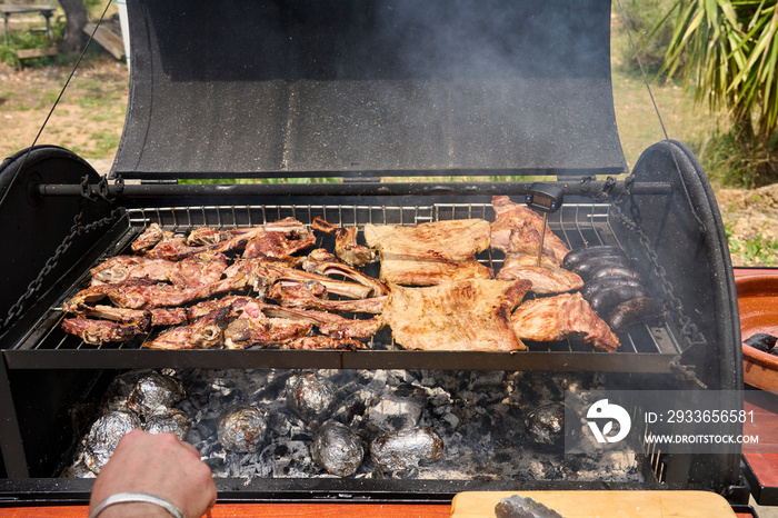 cooking on a charcoal and wood barbecue