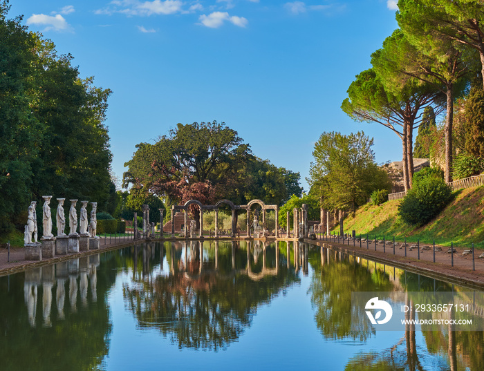 The Ancient Pool Canopus, surrounded by pine trees and greek sculptures in Hadrians Villa, Tivoli, 
