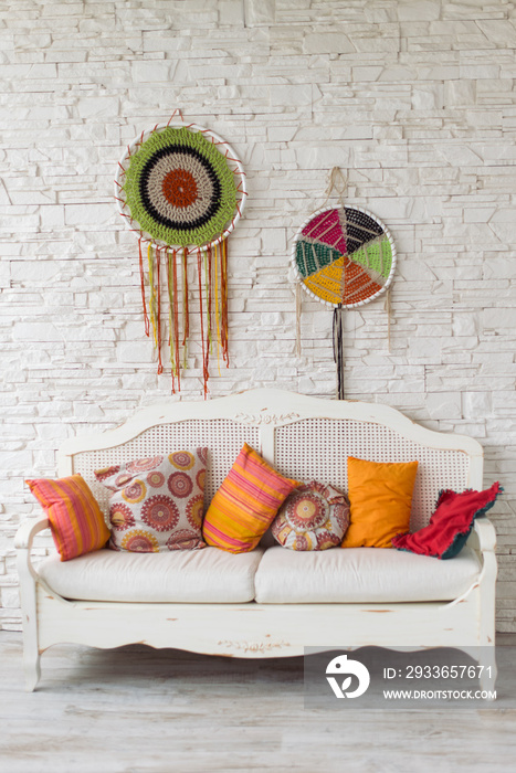 lantern and cozy sofa with pillows. Living room interior and home decor concept. Toned image