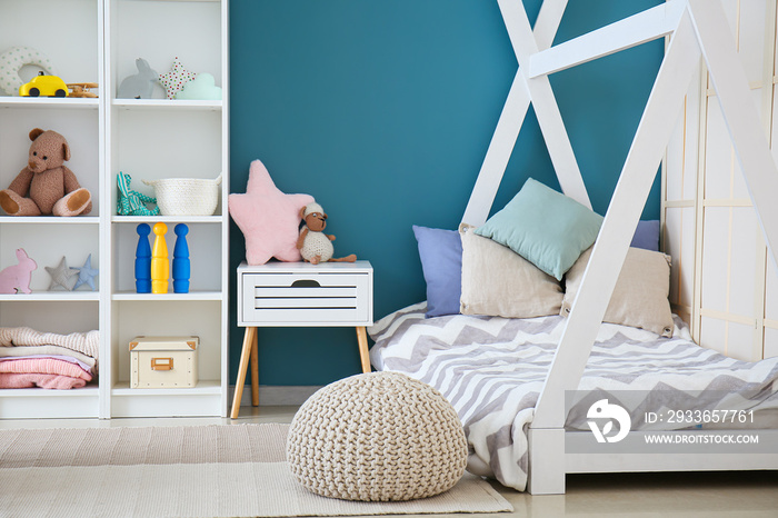 Stylish interior of childrens room with baby bed