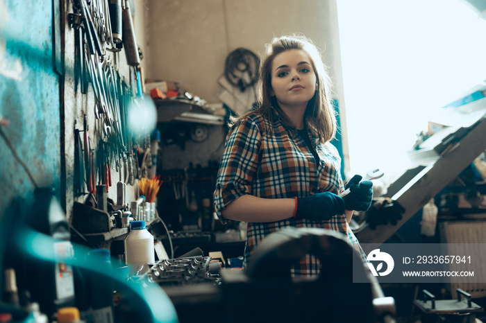 Female auto mechanic at auto service station, indoors. Gender equality. Work, occupation, fashion, j