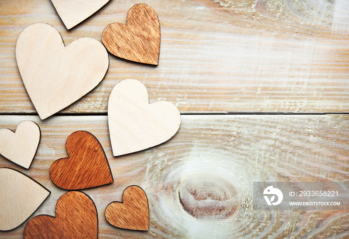 Lots of wooden hearts on the wooden table