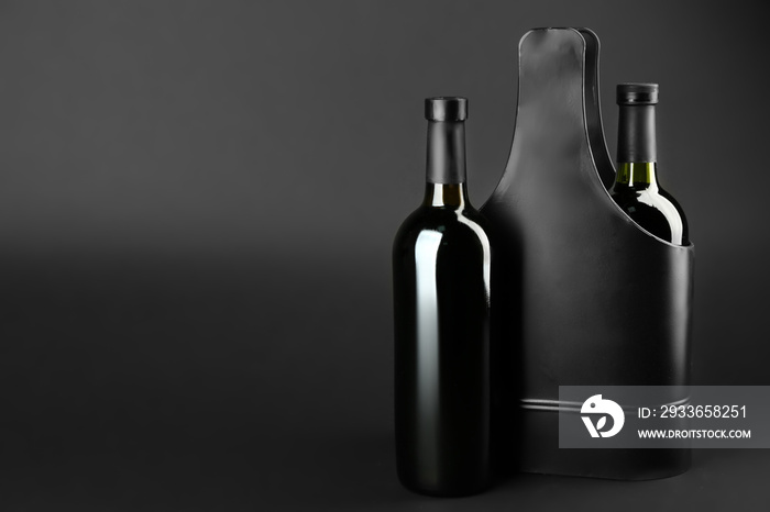 St. Valentines Day concept. Two wine bottles in black metal gift box on dark background