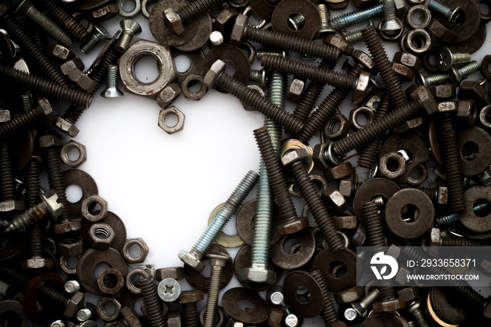 Assorted nuts and bolts shaped heart on white background.