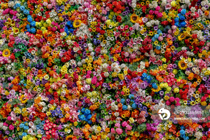 Multi colour of artificial flowers on backdrop with selective focus, Mixed colourful pattern texture