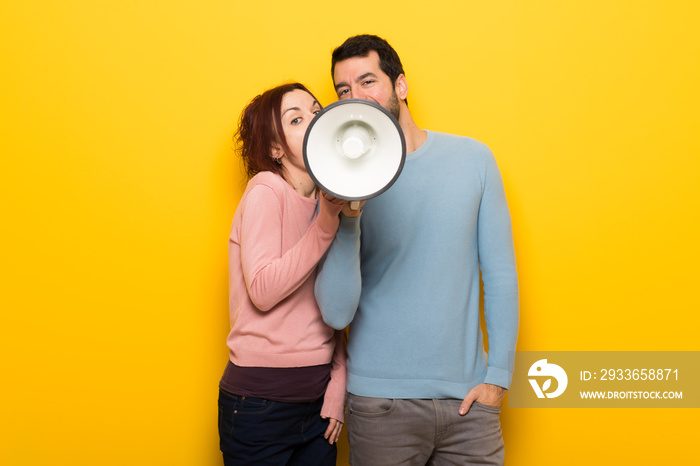 Couple in valentine day shouting through a megaphone