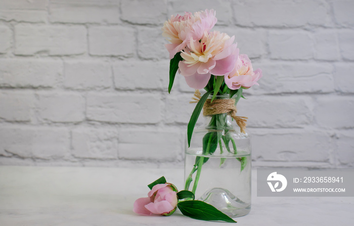 Beautiful peony flower in a vase on an old background