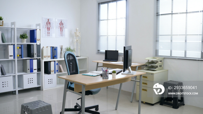 panoramic view of clean and white hospital office with sufficient natural light through louver windo