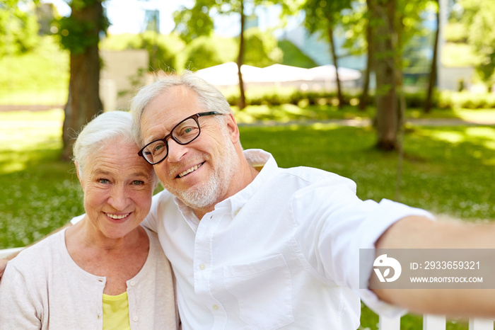 senior couple taking selfie at summer park